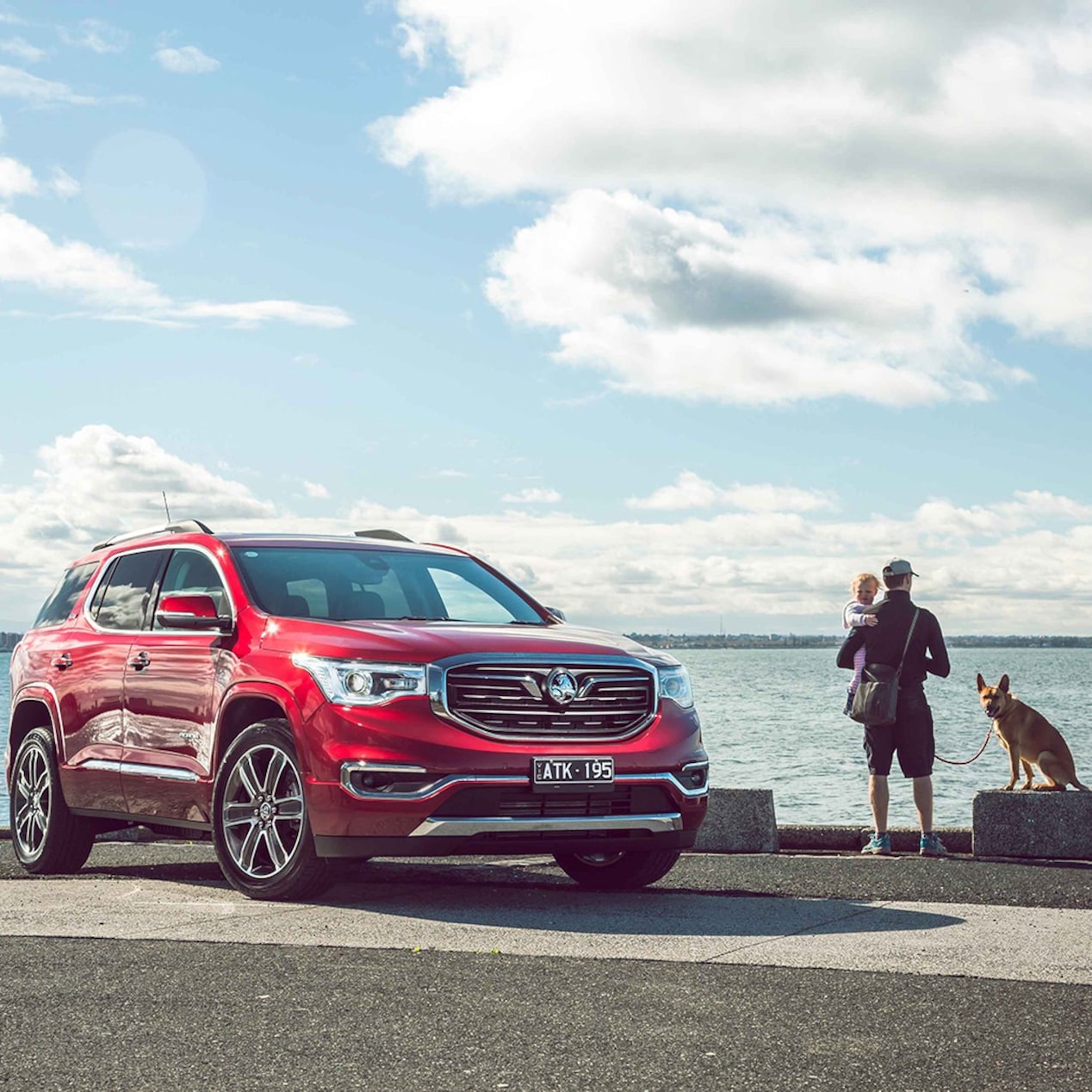 Family Standing Next to a Holden Acadia