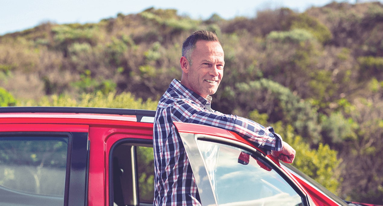 A Man Standing Next to a Vehicle